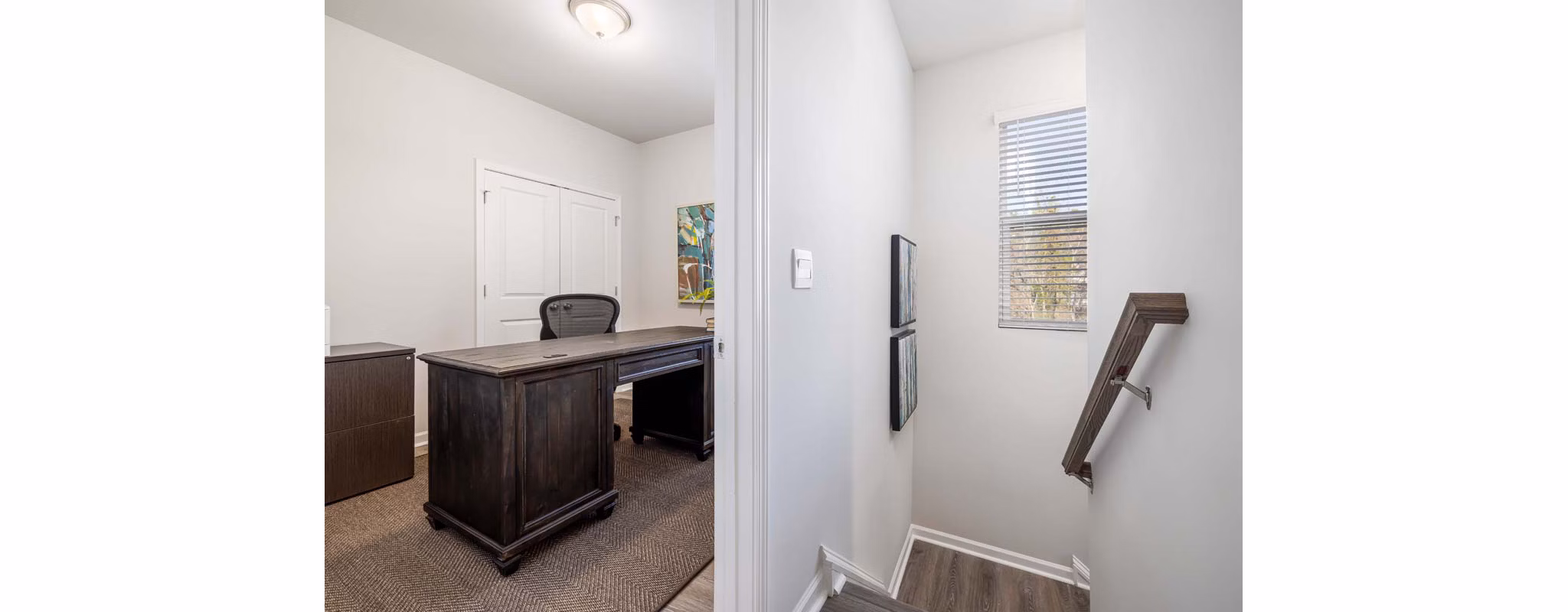 Modern hallway with elegant lighting and hardwood floors in Ashford Townes Apartments