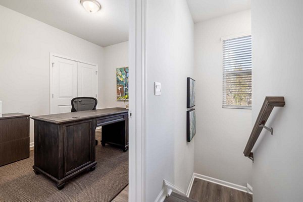 Modern hallway with elegant lighting and hardwood floors in Ashford Townes Apartments