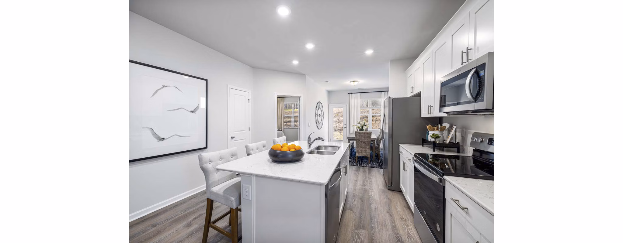 Modern kitchen with stainless steel appliances and granite countertops at Ashford Townes Apartments