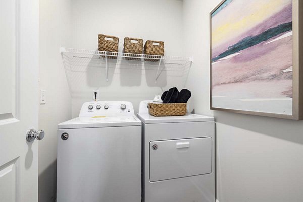 Laundry room with modern appliances at Ashford Townes Apartments