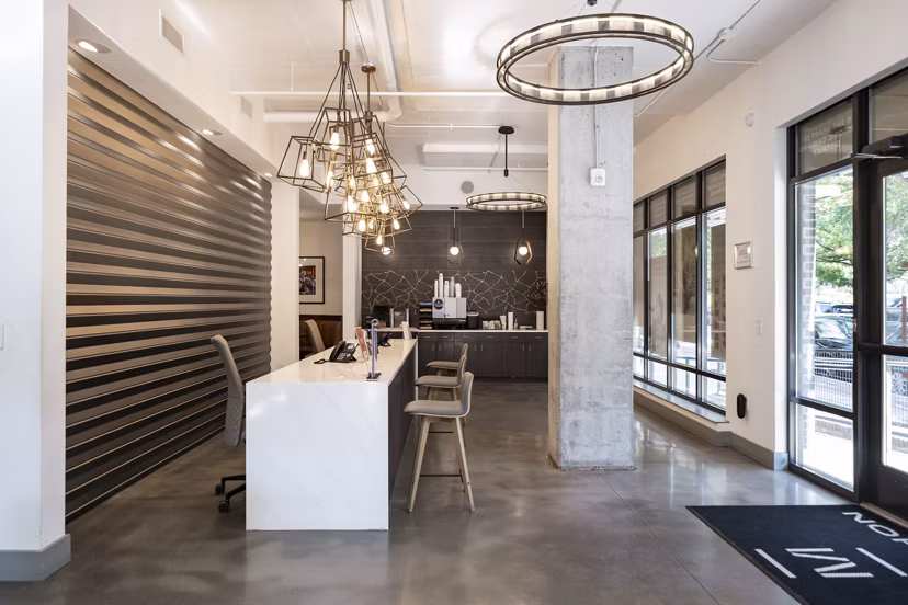 Clubhouse featuring modern design and seating areas at Marchon Apartments