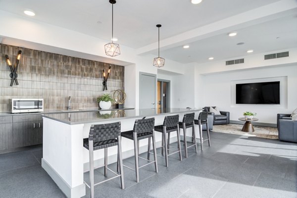 Clubhouse featuring modern design and seating areas at Marchon Apartments