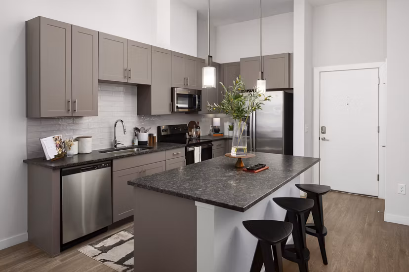 Modern kitchen with stainless steel appliances at Marchon Apartments