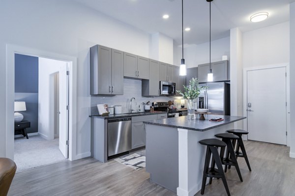 Modern kitchen with stainless steel appliances at Marchon Apartments