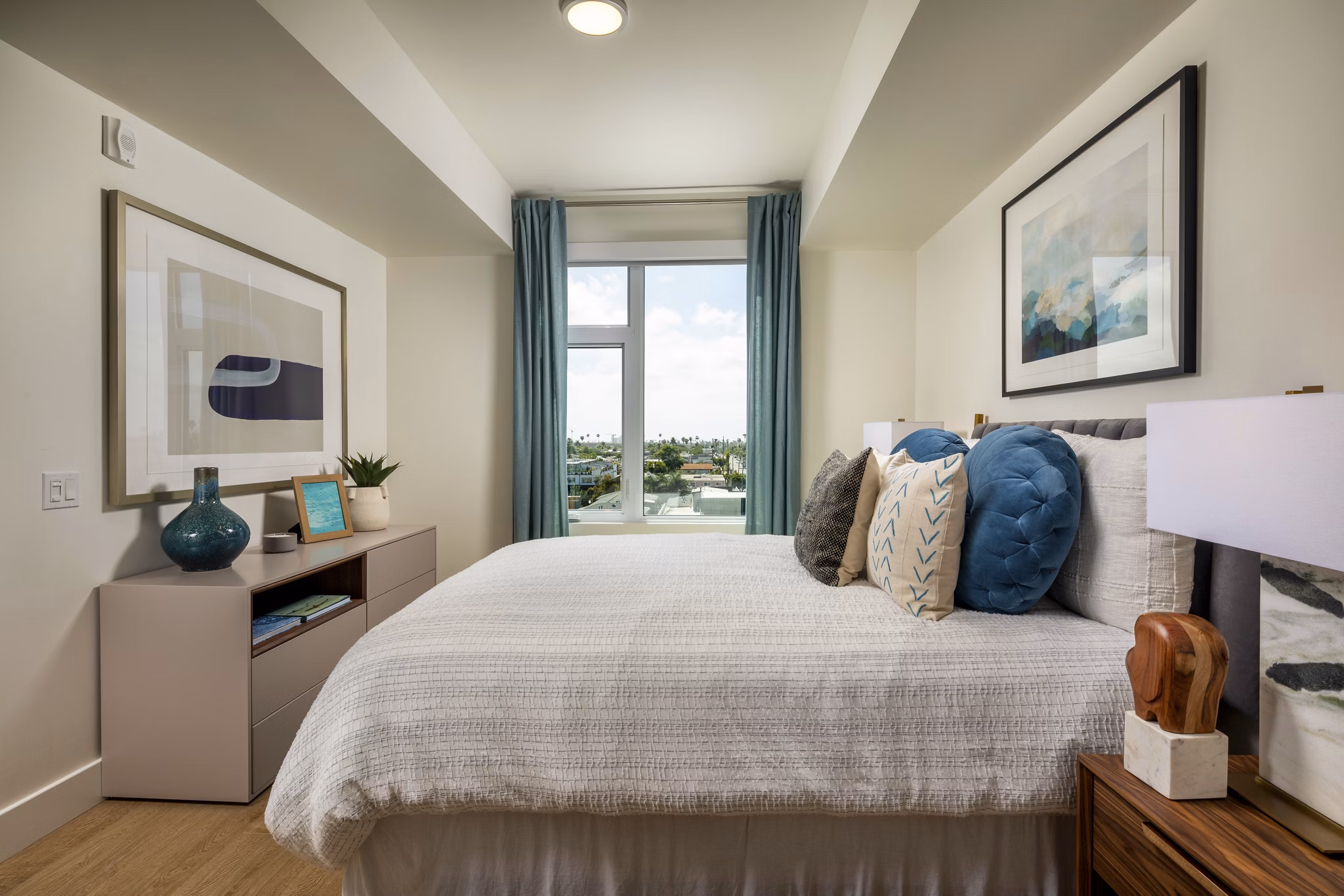 Bedroom with contemporary decor and large windows at Azul North Park Apartments, a Greystar luxury property in North Park neighborhood