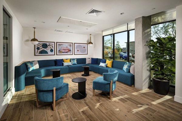 Modern clubhouse at Azul North Park Apartments featuring stylish interiors and community seating areas