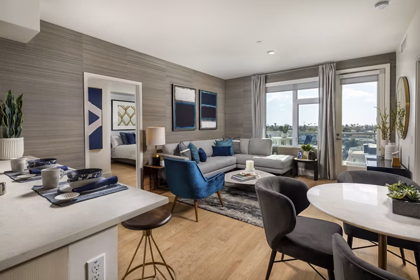 Dining area with modern furniture and large windows in Azul North Park Apartments