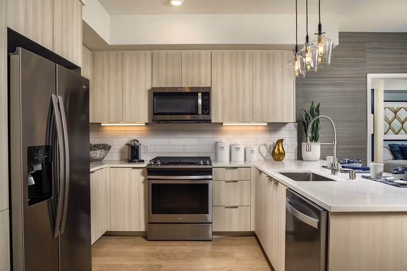 Sleek modern kitchen with stainless steel appliances in Azul North Park Apartments