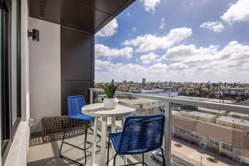 Sunny patio featuring modern furniture at Azul North Park Apartments in a  community