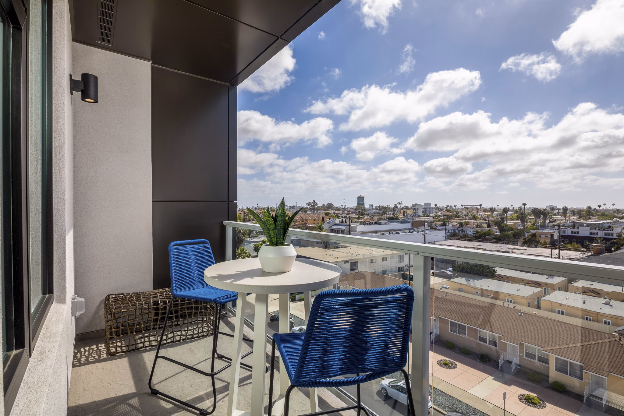 Sunny patio featuring modern furniture at Azul North Park Apartments in a  community