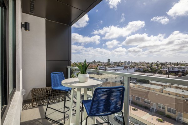 Sunny patio featuring modern furniture at Azul North Park Apartments in a  community