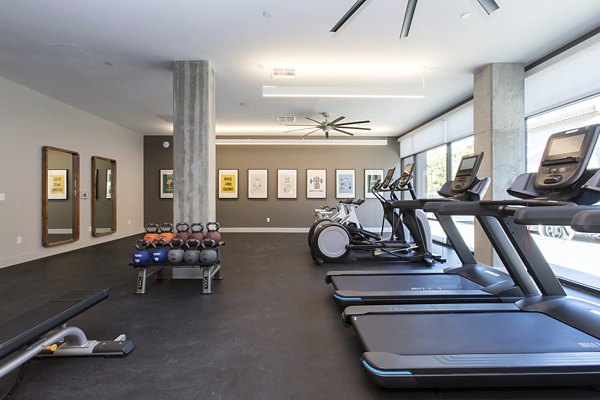 Modern fitness center with state-of-the-art equipment at The Moran Apartments for resident wellness and activity