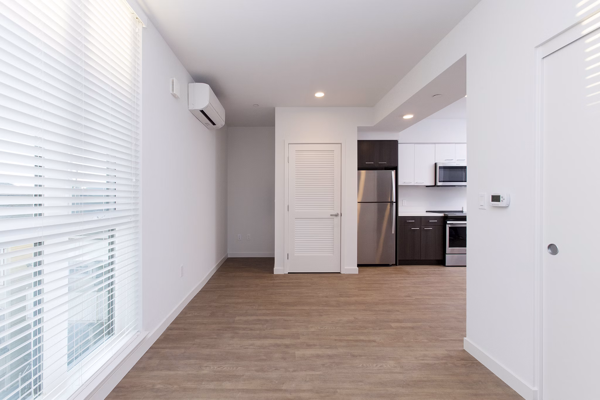 Spacious living room with modern decor in The Moran Apartments, featuring luxury finishes and abundant natural light