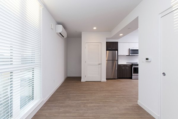 Spacious living room with modern decor in The Moran Apartments, featuring luxury finishes and abundant natural light