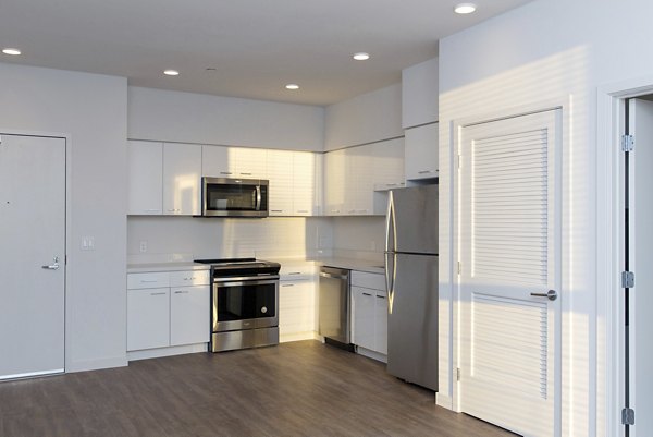 Contemporary kitchen with stainless steel appliances in The Moran Apartments