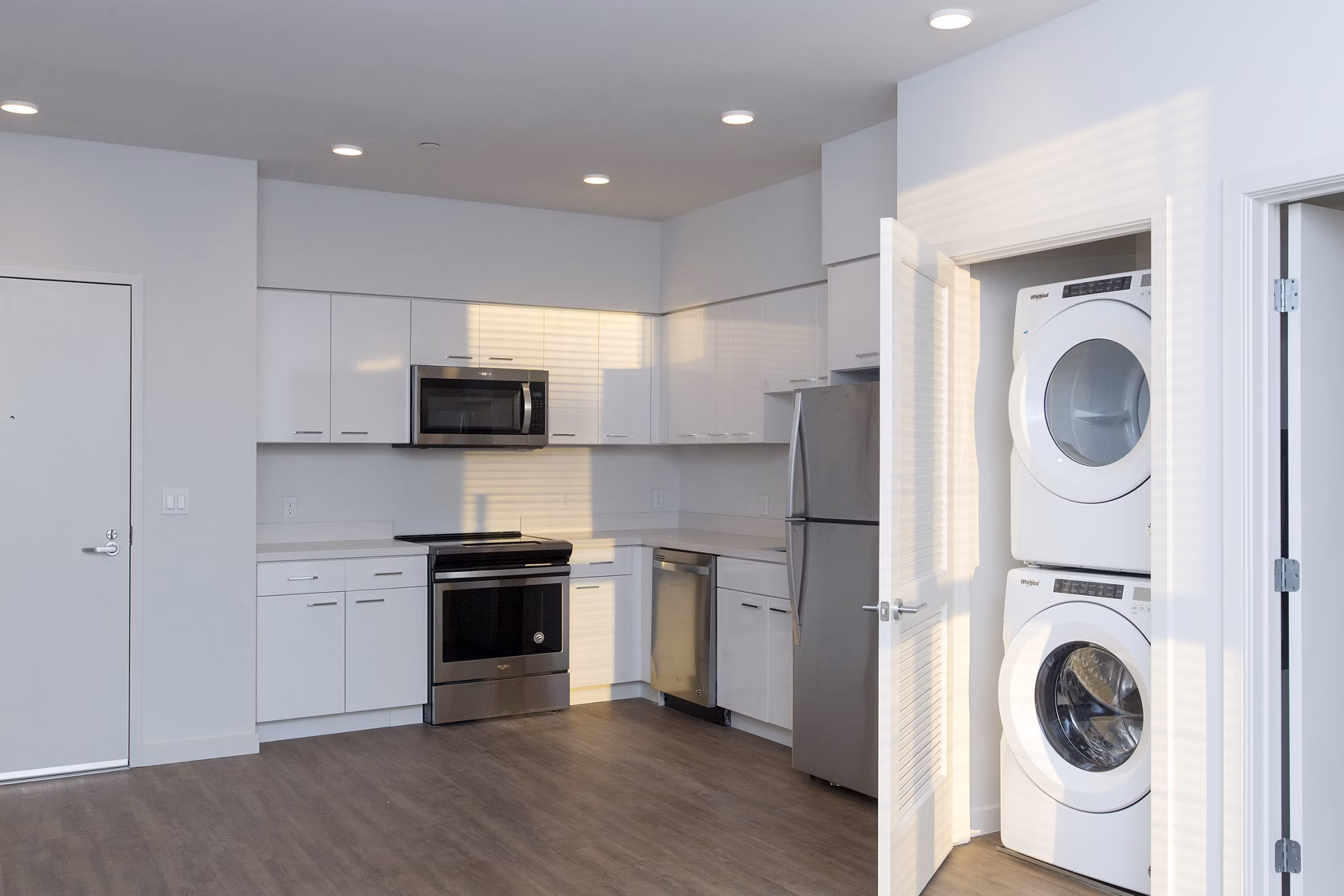 Modern laundry room with stainless steel appliances in The Moran Apartments