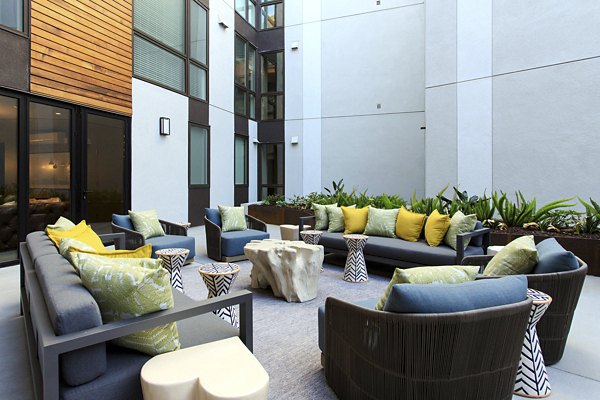 Courtyard featuring modern seating and lush greenery at The Moran Apartments, a Greystar luxury community