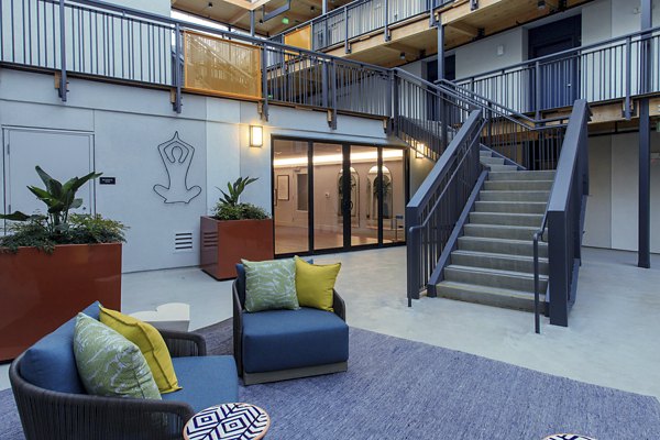 Courtyard with lush greenery and seating areas at The Moran Apartments