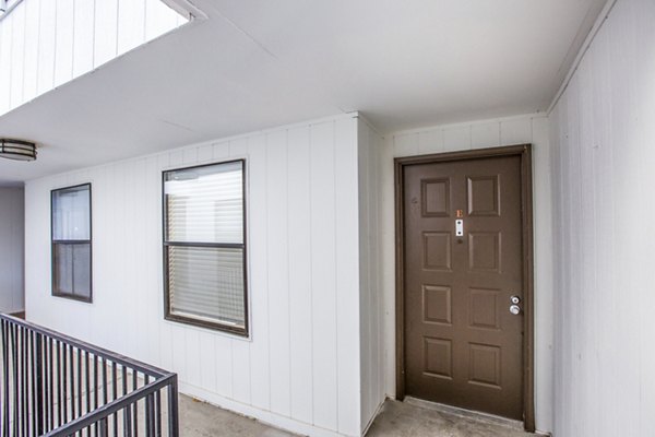 Canoan Village Apartments: Elegant entryway with landscaped gardens in a luxury apartment community