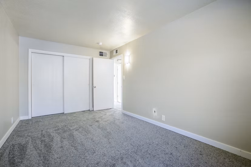 Cozy bedroom with elegant decor at Canoan Village Apartments featuring luxury furnishings and ambient lighting