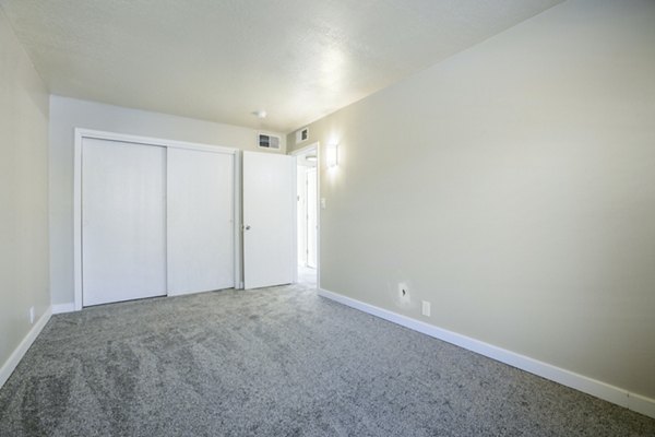 Cozy bedroom with elegant decor at Canoan Village Apartments featuring luxury furnishings and ambient lighting