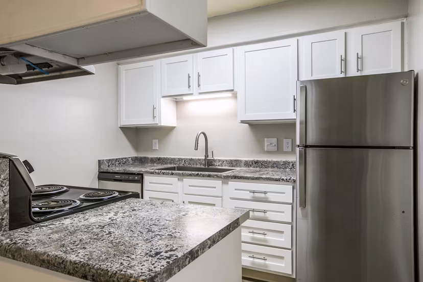 Modern kitchen with sleek countertops and stainless appliances at Canoan Village Apartments, luxury living by Greystar
