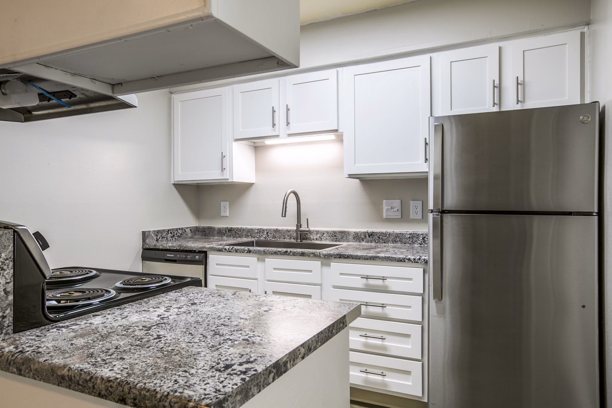 Modern kitchen with sleek countertops and stainless appliances at Canoan Village Apartments, luxury living by Greystar