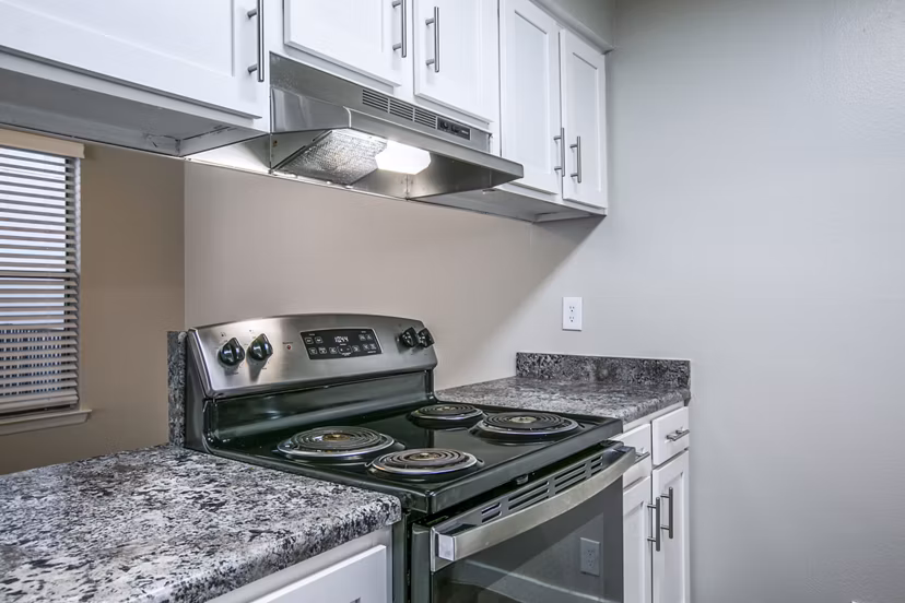 Modern kitchen with stainless steel appliances at Canoan Village Apartments