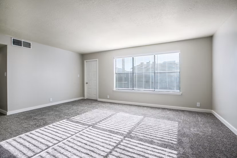 Modern living room featuring sleek decor and large windows in Canoan Village Apartments
