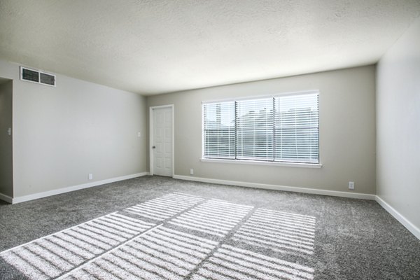 Modern living room featuring sleek decor and large windows in Canoan Village Apartments