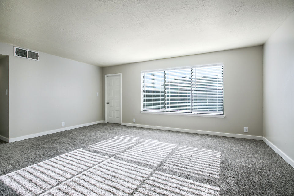 Modern living room featuring sleek decor and large windows in Canoan Village Apartments