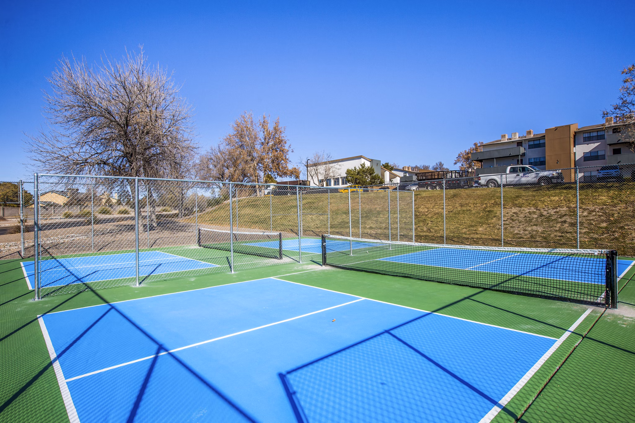 Tennis court with modern design at Canoan Village Apartments, providing luxury recreational facilities for residents