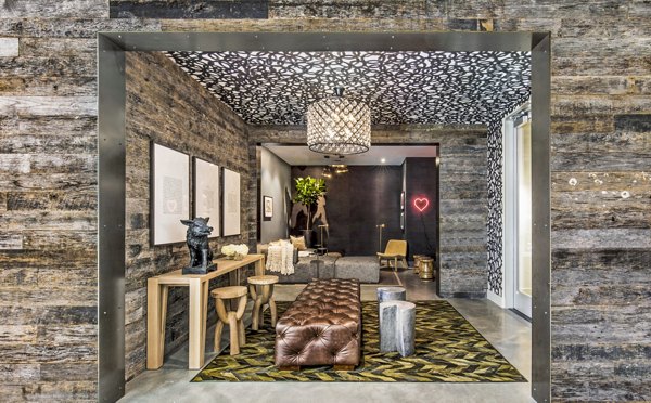 Clubhouse lobby featuring modern art and seating at Telegraph Arts Apartments, a Greystar luxury apartment community