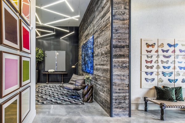 Welcoming clubhouse lobby with modern art and seating at Telegraph Arts Apartments