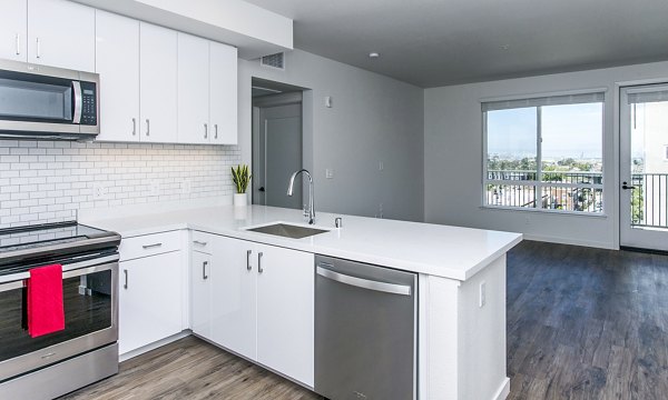 Modern kitchen with stainless steel appliances at Telegraph Arts Apartments