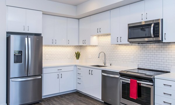 Modern kitchen with sleek cabinetry and stainless steel appliances at Telegraph Arts Apartments