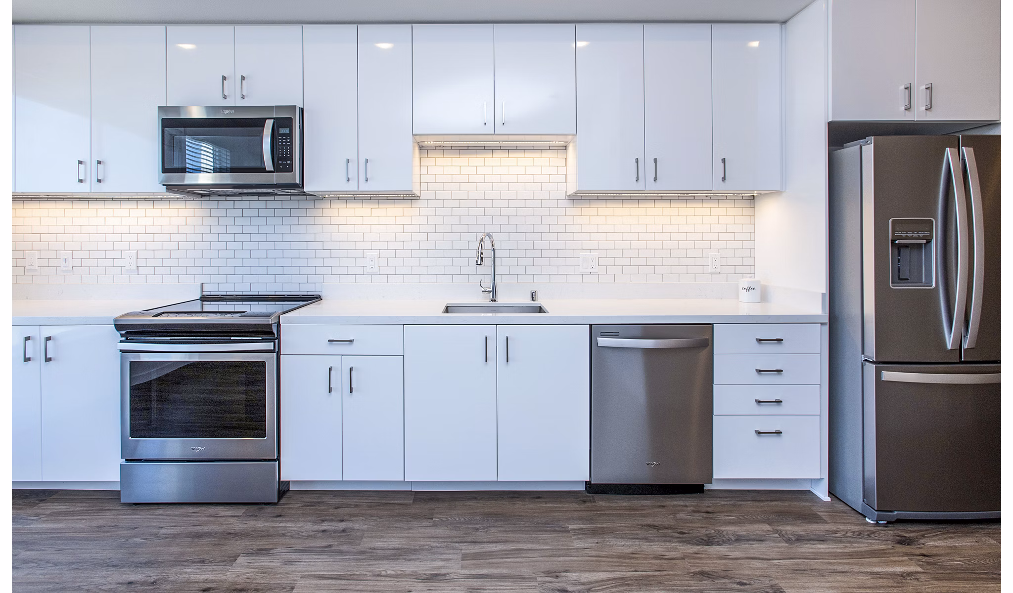 Modern kitchen with stainless steel appliances at Telegraph Arts Apartments