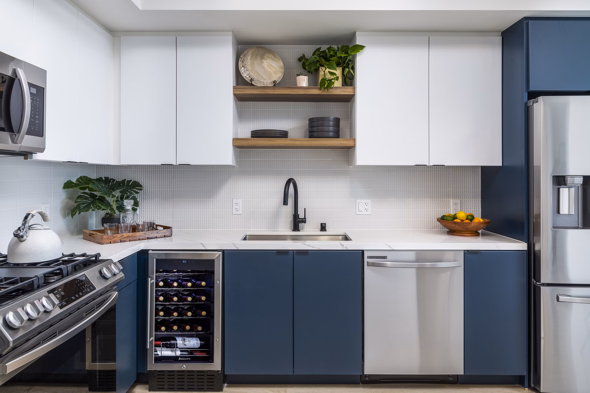 Modern kitchen with stainless steel appliances at The Charlie Mar Vista Apartments