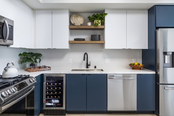 Modern kitchen with stainless steel appliances at The Charlie Mar Vista Apartments