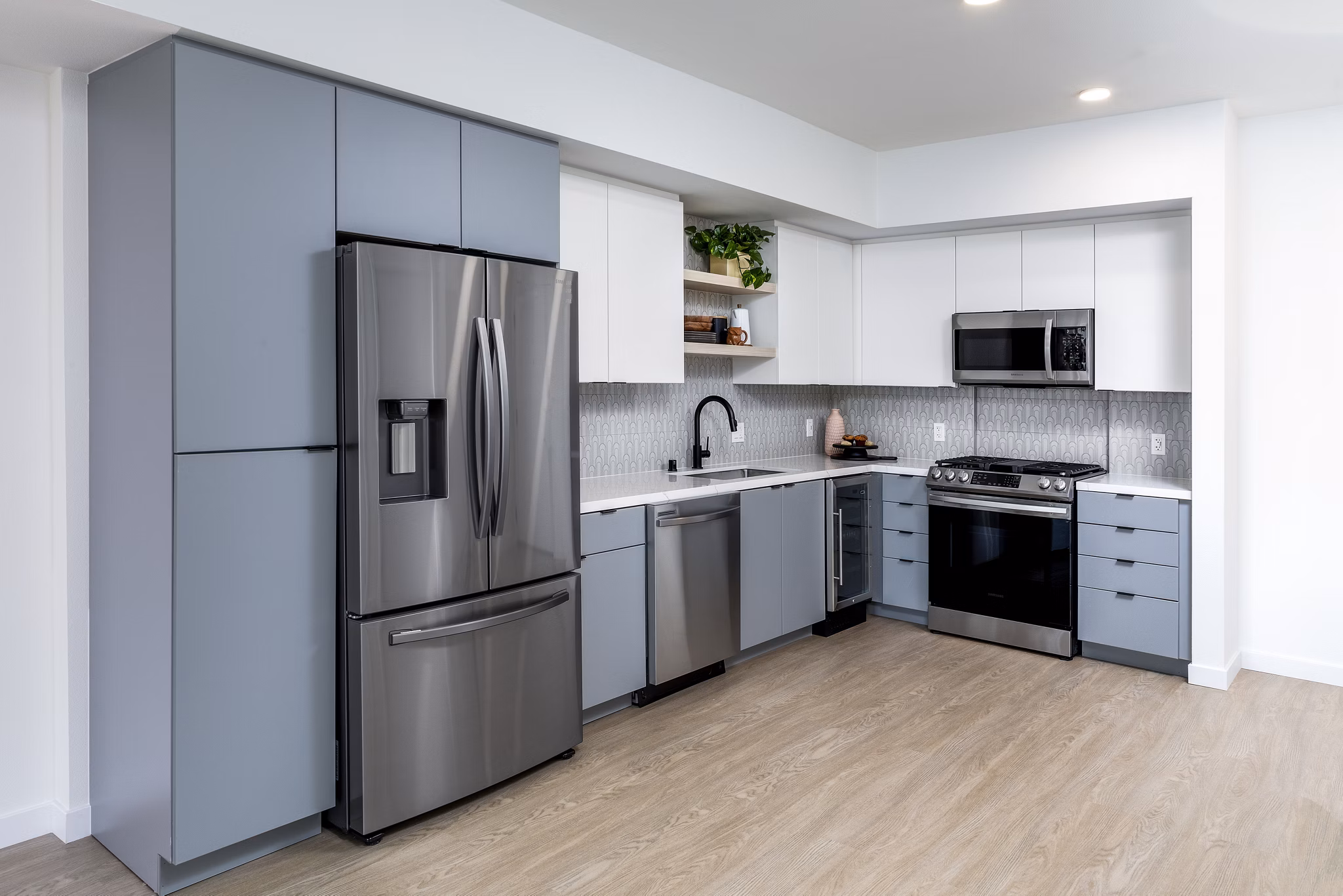 Modern kitchen with stainless steel appliances at The Charlie Mar Vista Apartments