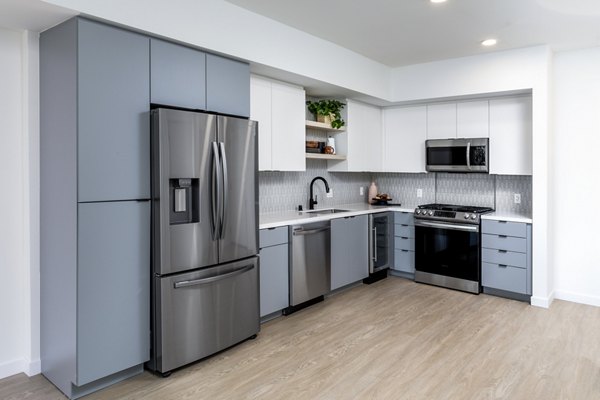 Modern kitchen with stainless steel appliances at The Charlie Mar Vista Apartments