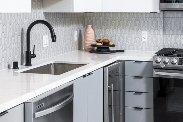 Modern kitchen featuring stainless steel appliances at The Charlie Mar Vista Apartments