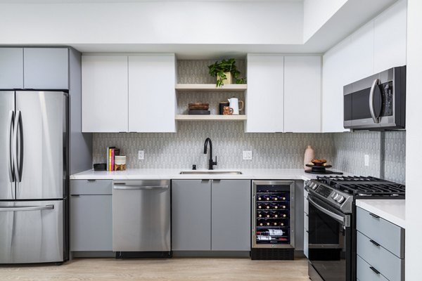 Modern kitchen with stainless steel appliances at The Charlie Mar Vista Apartments
