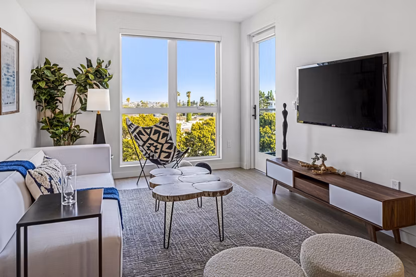 Spacious living room with modern dÃ©cor in The Charlie Mar Vista apartments, ideal for luxury living in a Greystar community