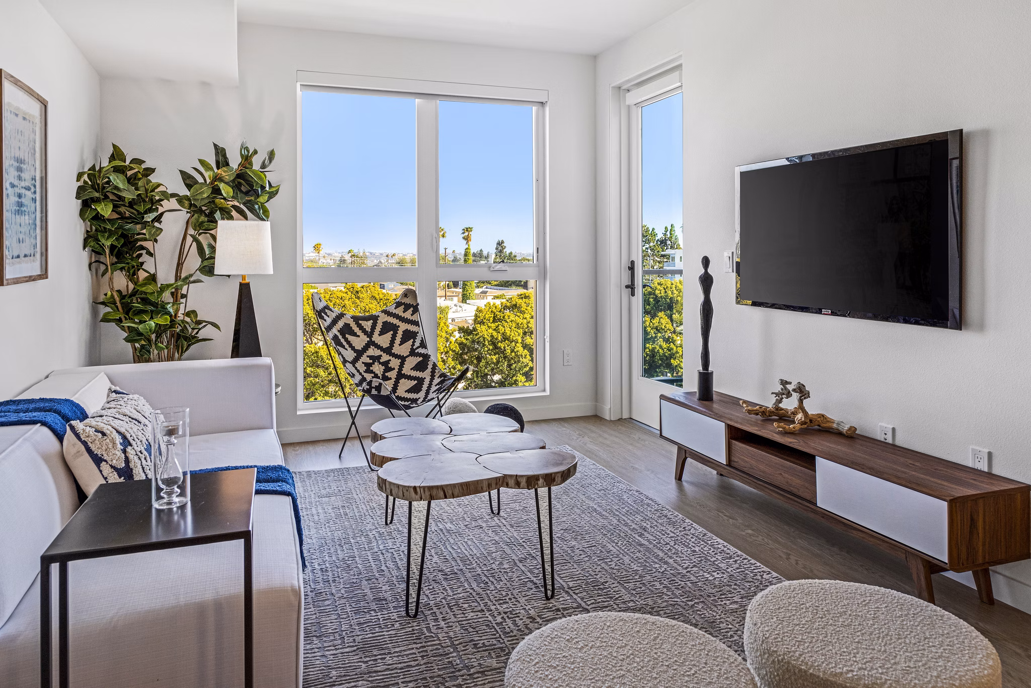 Spacious living room with modern dÃ©cor in The Charlie Mar Vista apartments, ideal for luxury living in a Greystar community