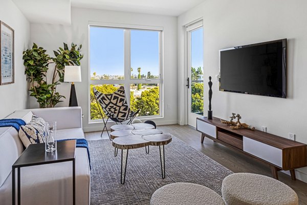 Spacious living room with modern dÃ©cor in The Charlie Mar Vista apartments, ideal for luxury living in a Greystar community