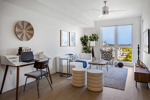 Stylish living room with natural light and modern decor at The Charlie Mar Vista Apartments