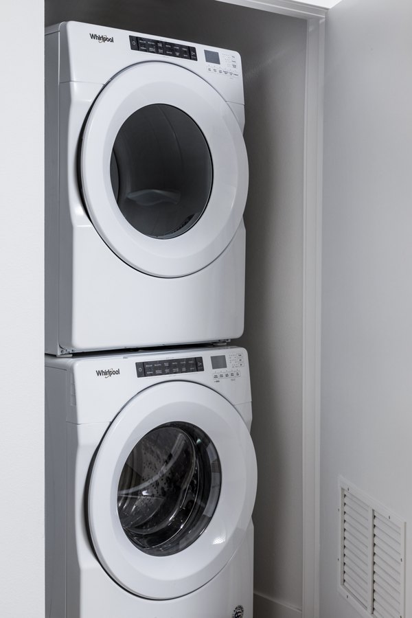 Modern laundry room with state-of-the-art washers and dryers at The Charlie Mar Vista Apartments