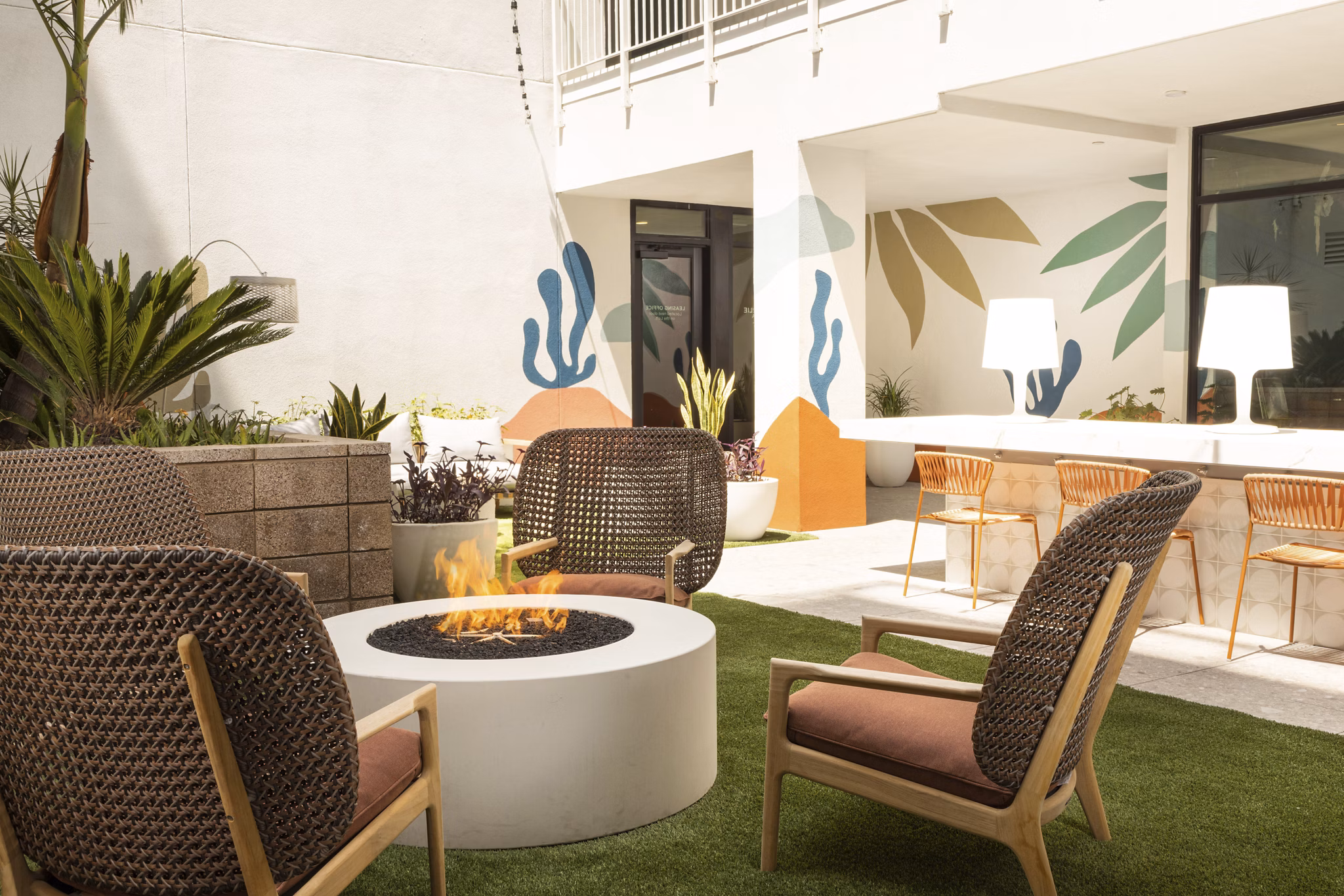Fire pit with seating area at The Charlie Mar Vista Apartments in Los Angeles, providing a cozy outdoor amenity for residents
