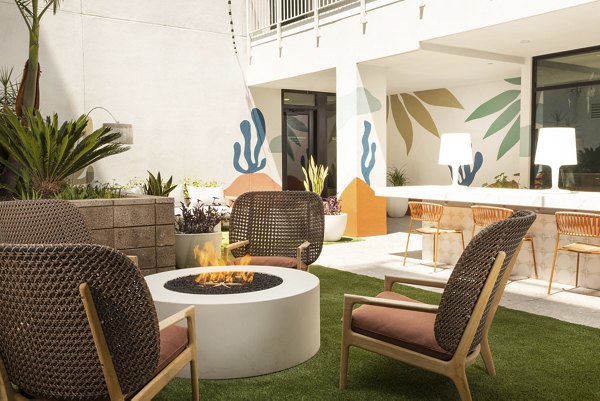 Fire pit with seating area at The Charlie Mar Vista Apartments in Los Angeles, providing a cozy outdoor amenity for residents